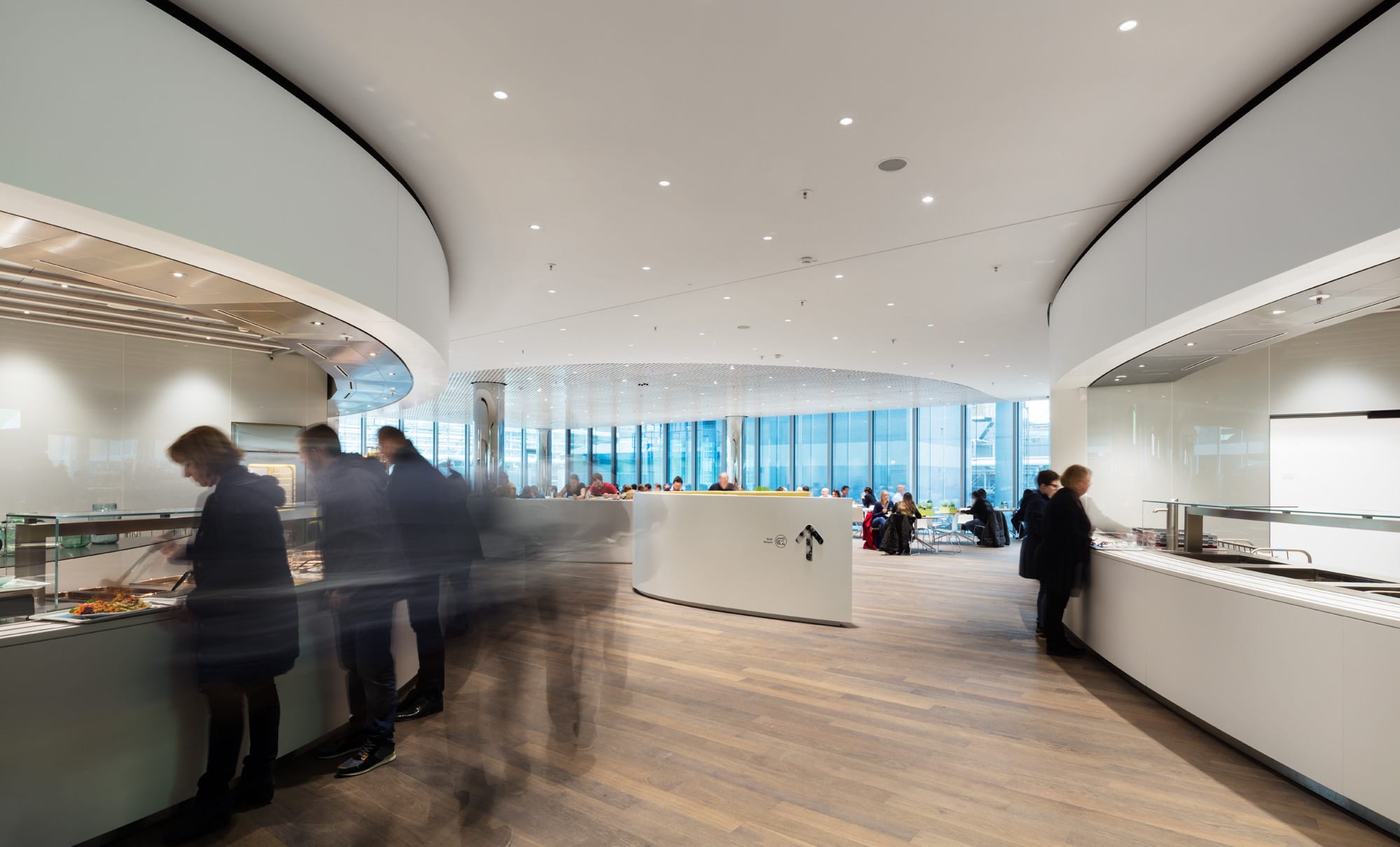 Moderne Kantine mit Personen und Buffetbereich.
